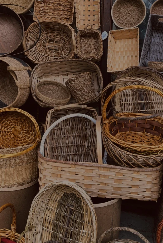 a pile of baskets sitting on top of a pile of wooden bowls