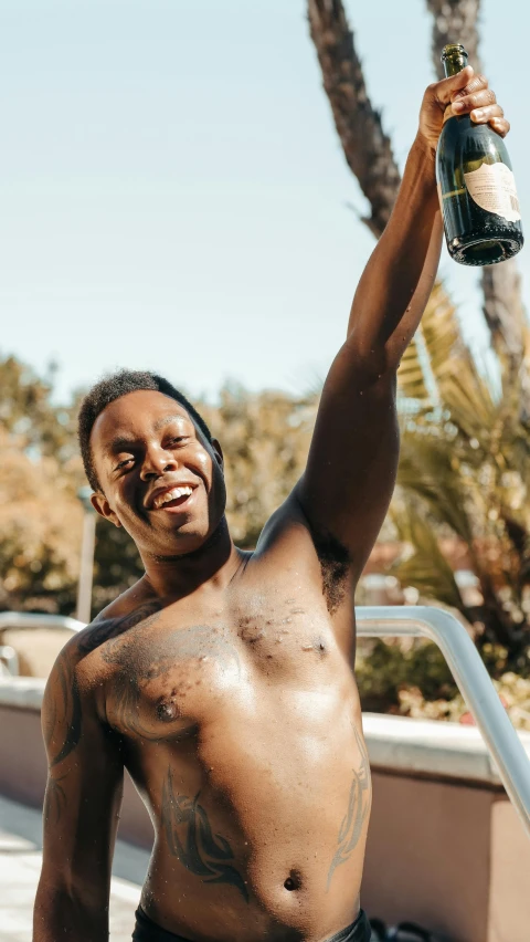 a black man with  holding a bottle of wine in his hand