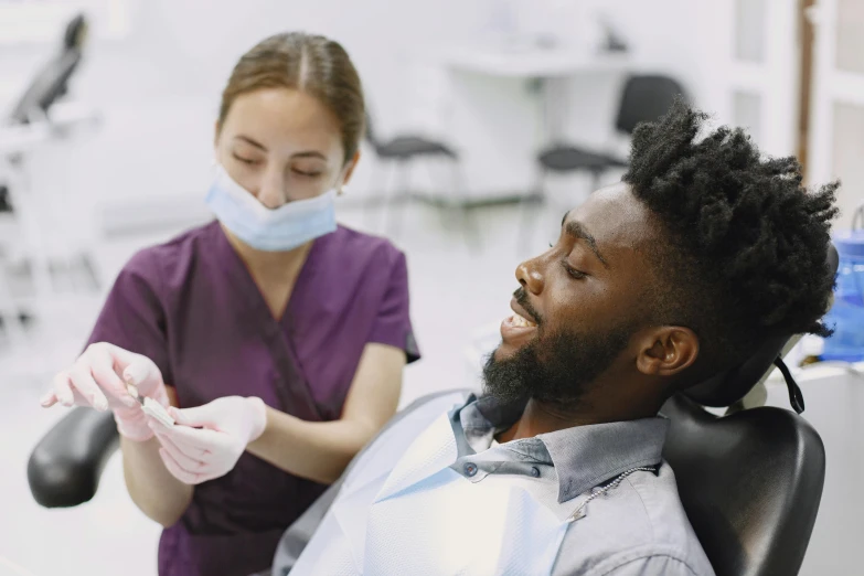 two men are working together in a dental office