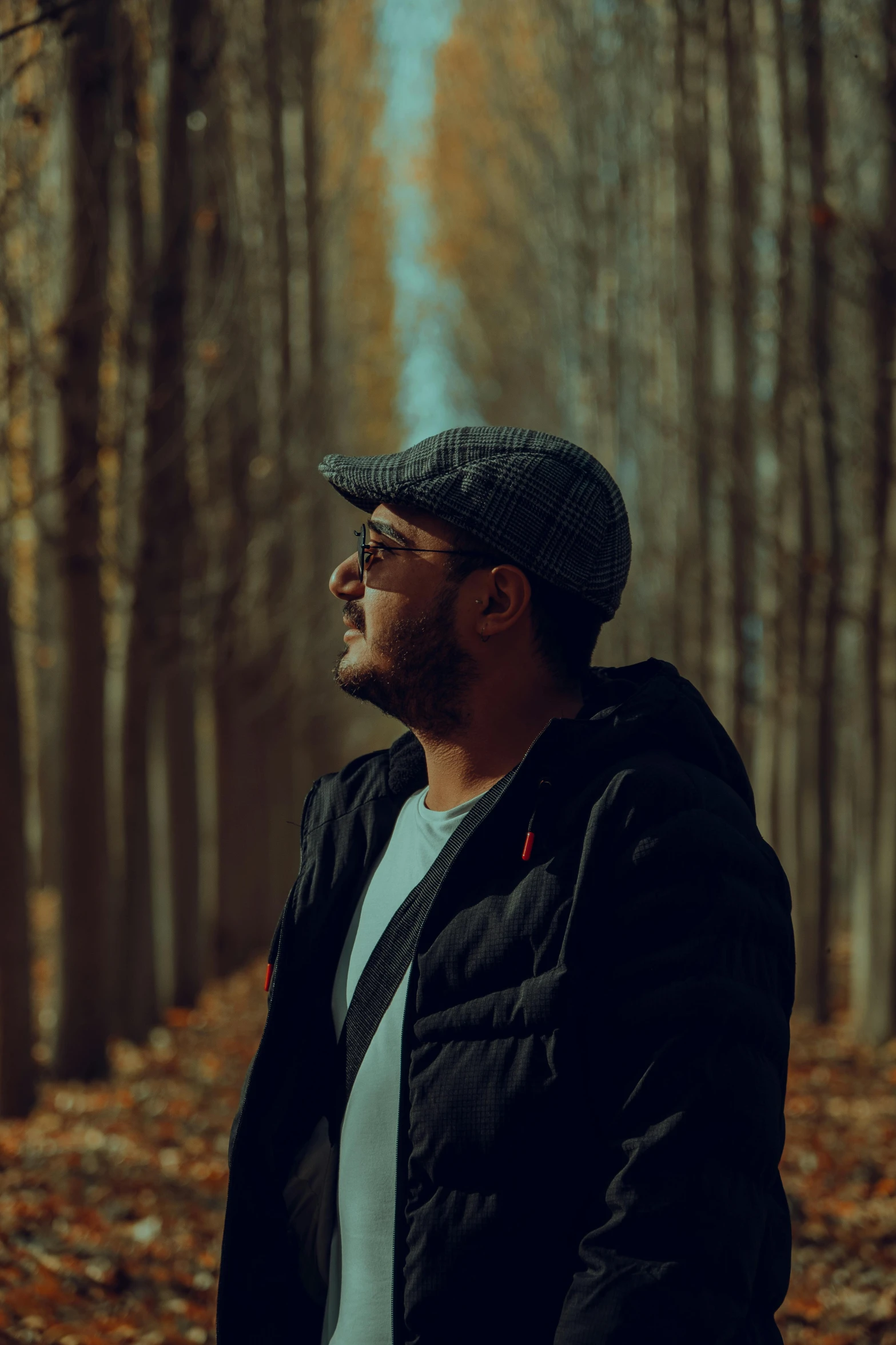 a man wearing a hat in a forest