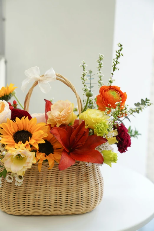 a wicker basket filled with flowers on top of a table