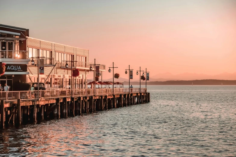 a small pier at dusk in the ocean