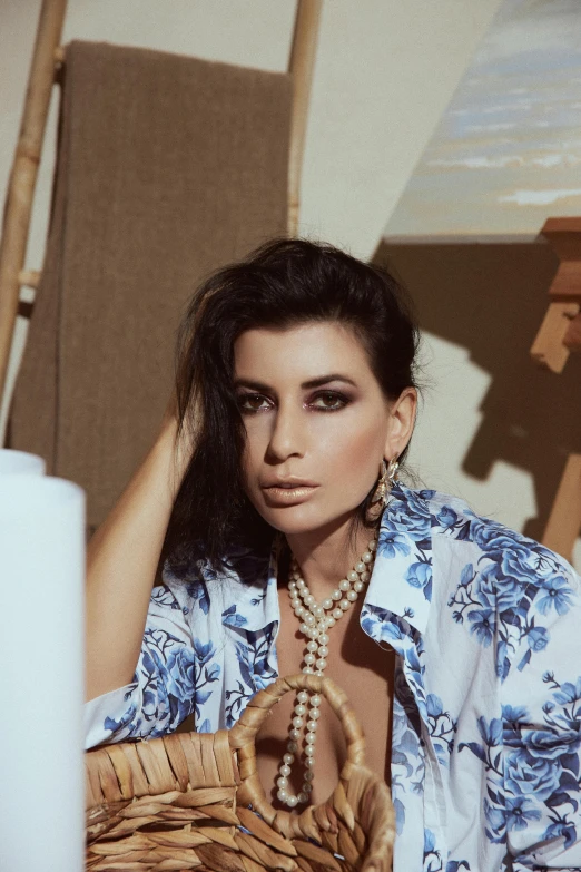 a woman posing in front of a mirror and wearing a large necklace