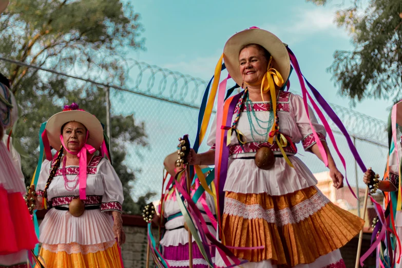 four woman dressed in mexican attire performing at an event