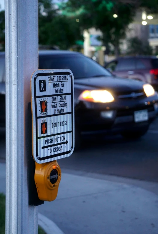 a street sign is on the pole in front of cars