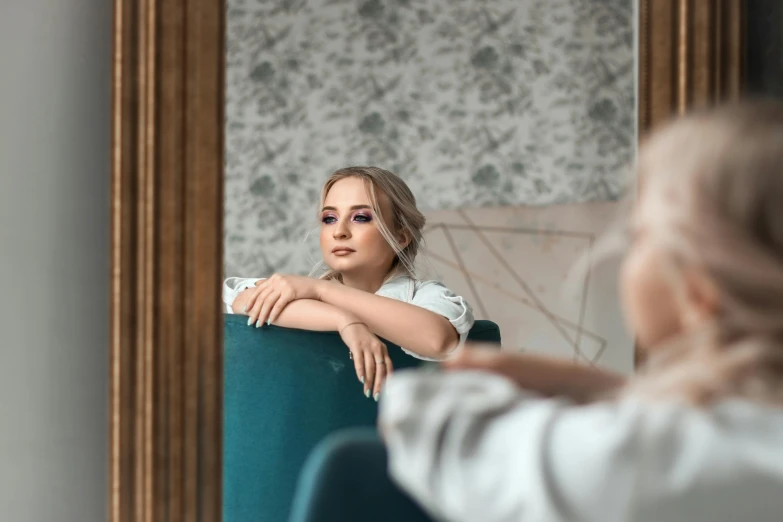 a beautiful woman sitting on top of a green chair