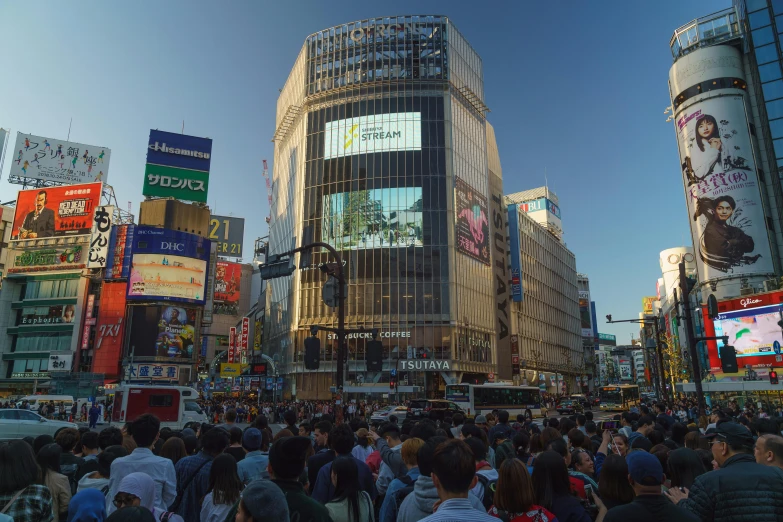 a crowded street in a city with tall buildings