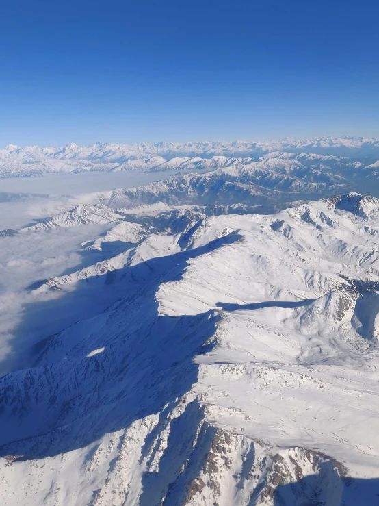 the view from a plane looking at a large mountain range