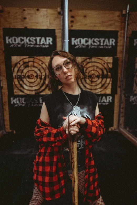 a girl is posing in a booth with her skateboard