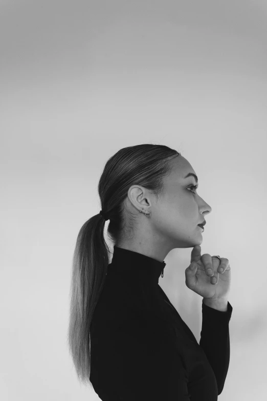 a woman with a pony tail wearing black clothes