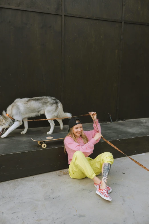 the lady smiles while her dog walks her leash