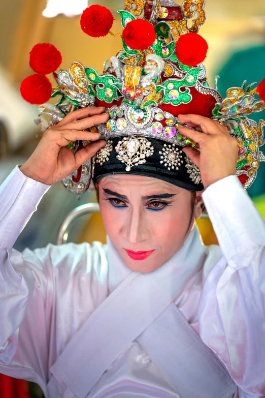 a woman wearing a large elaborate headdress,