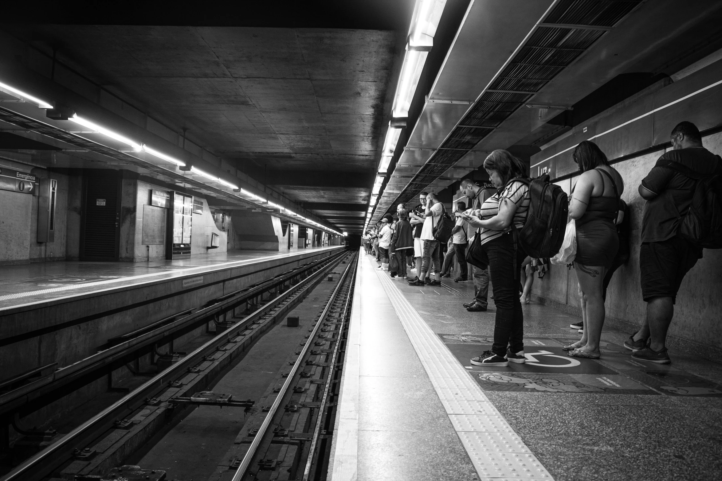 people are waiting for a train at the station