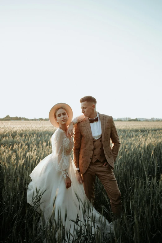 a couple in a field wearing vintage fashion