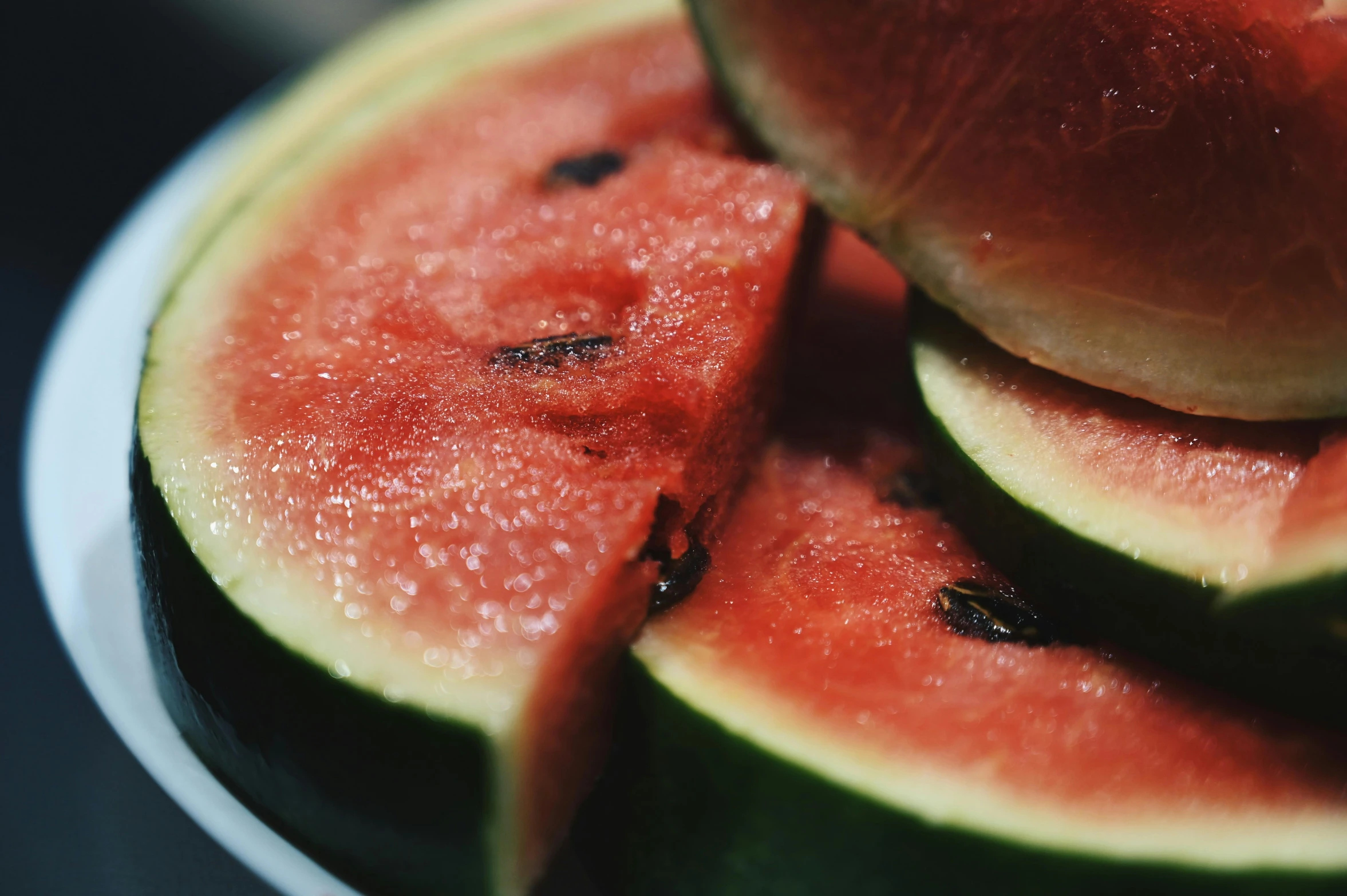 slices of watermelon sit on a plate