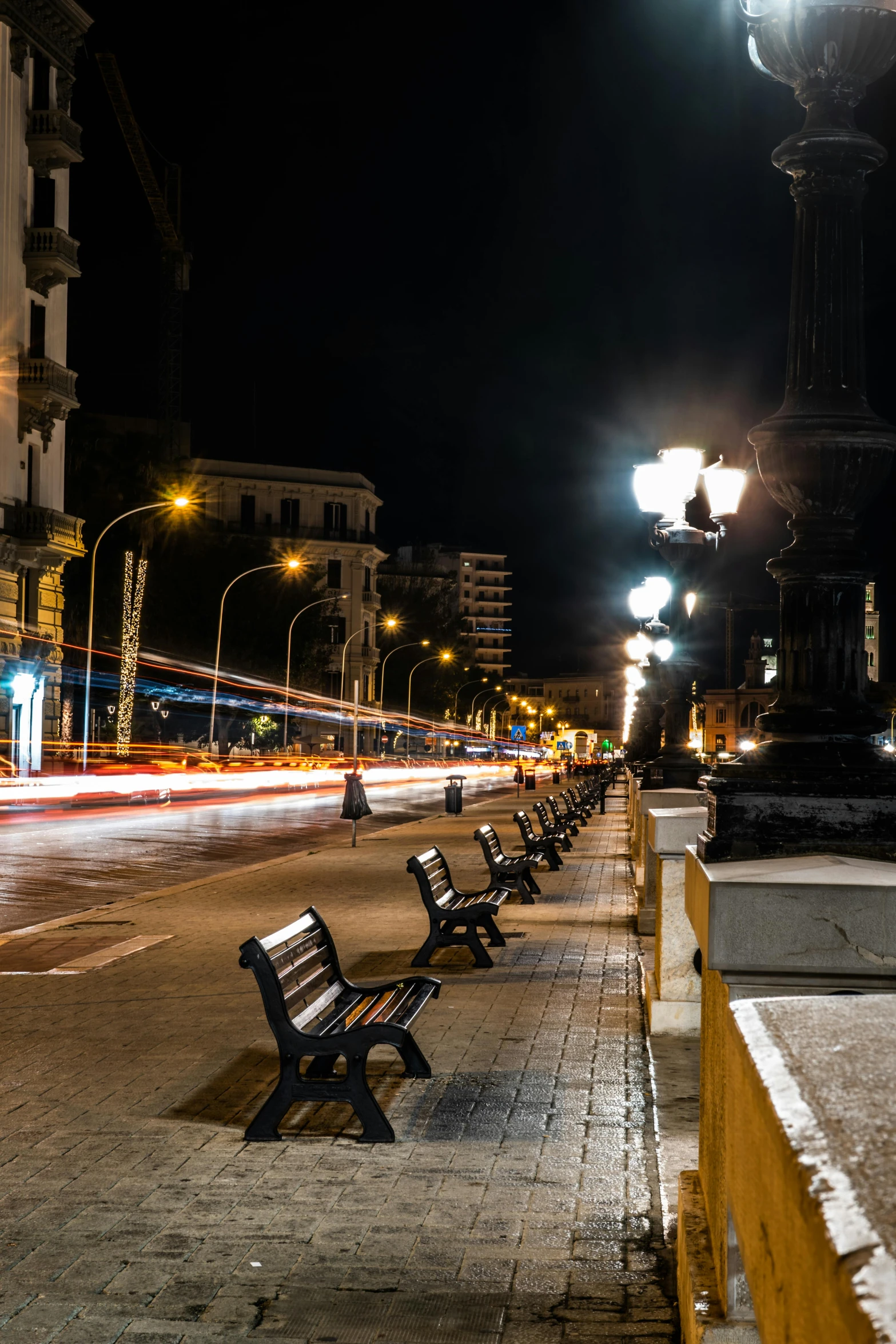 empty benches along a city street at night