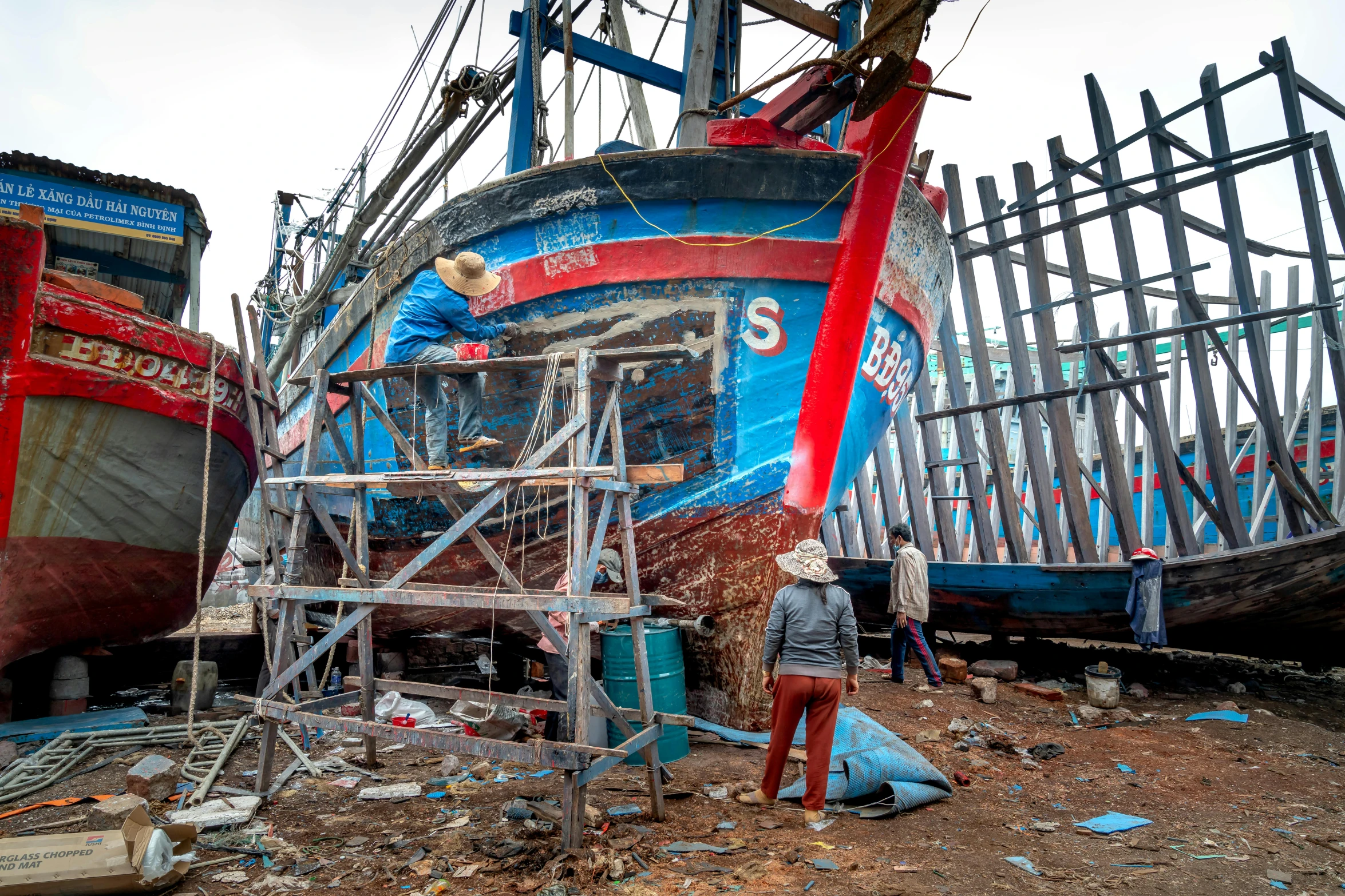 a woman looks at the damage on an abandoned ship