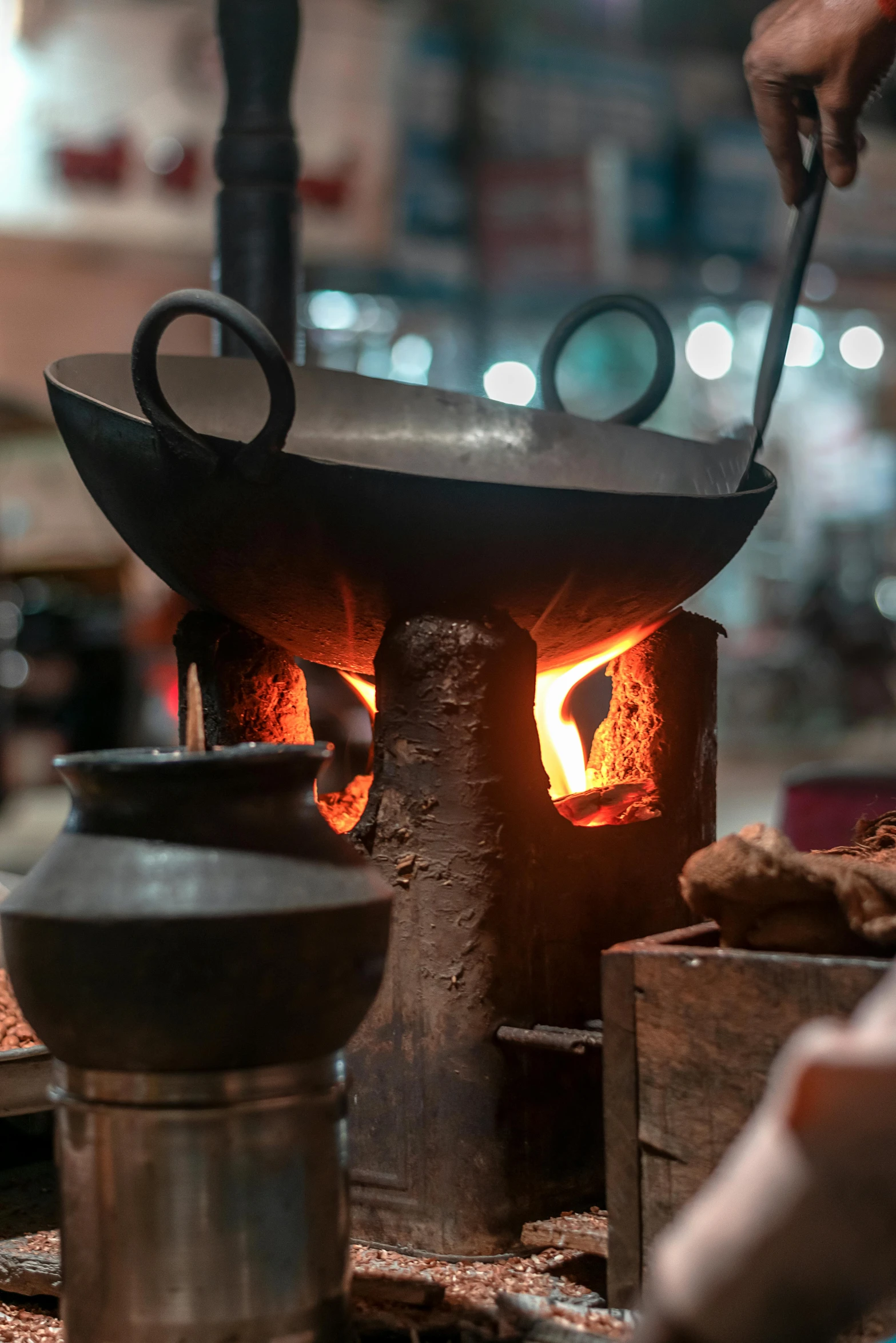 an old metal pot with a black handle near a burner