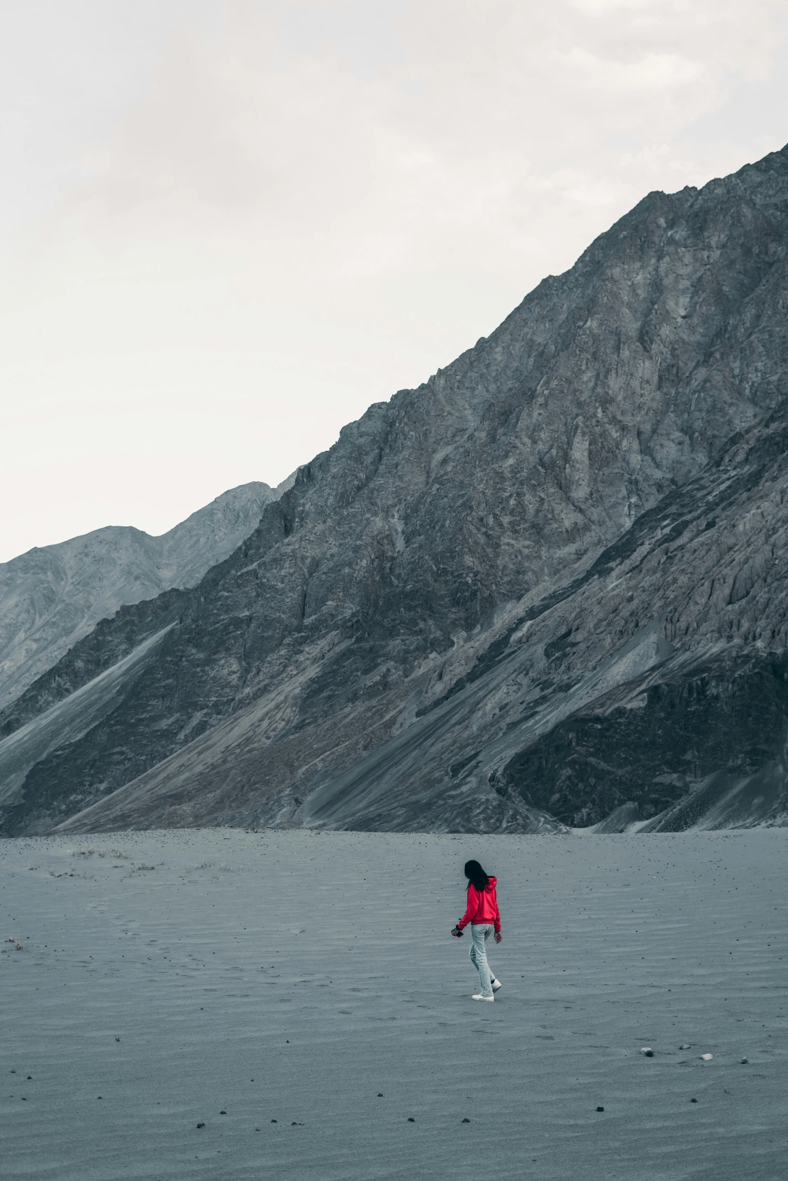 a person is walking away in the mountains