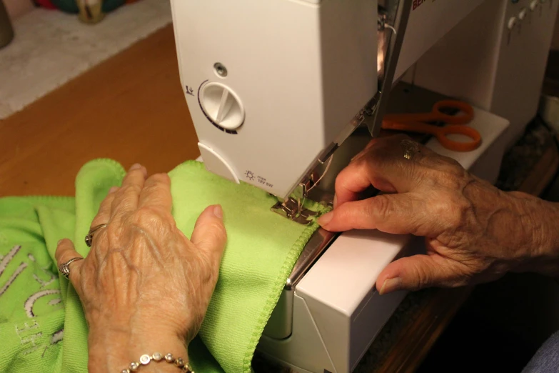 a person is sewing soing on a machine