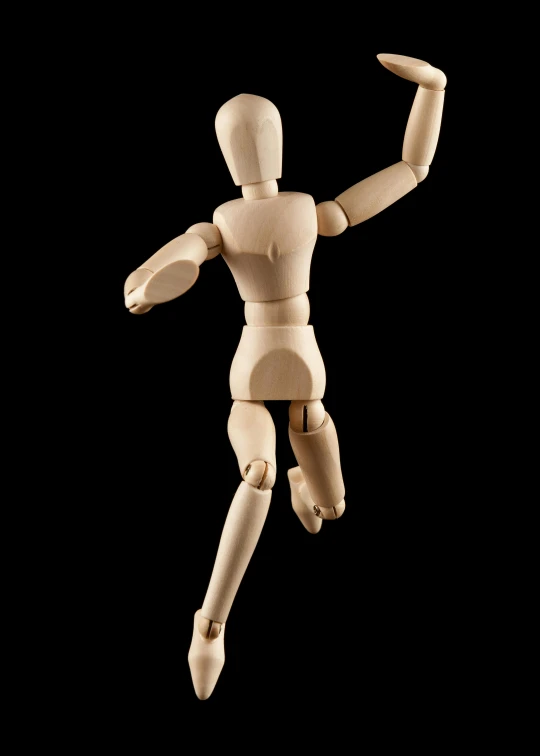 a wooden doll standing upright in the air