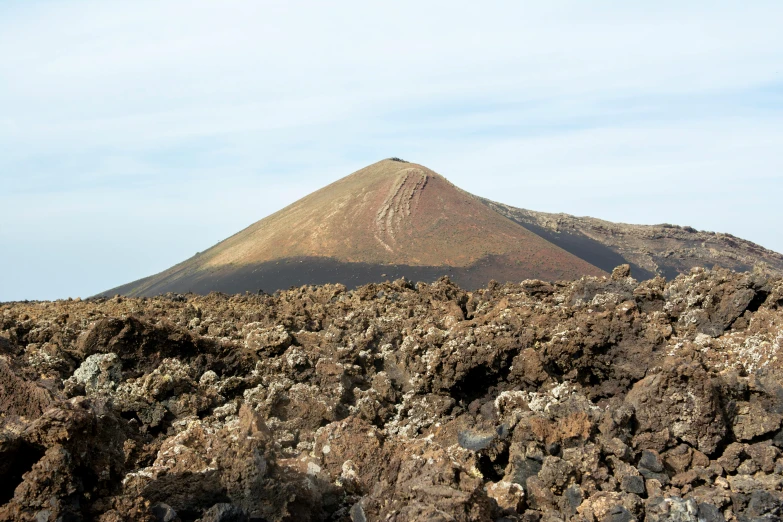 a very tall mountain in the background with rock formations