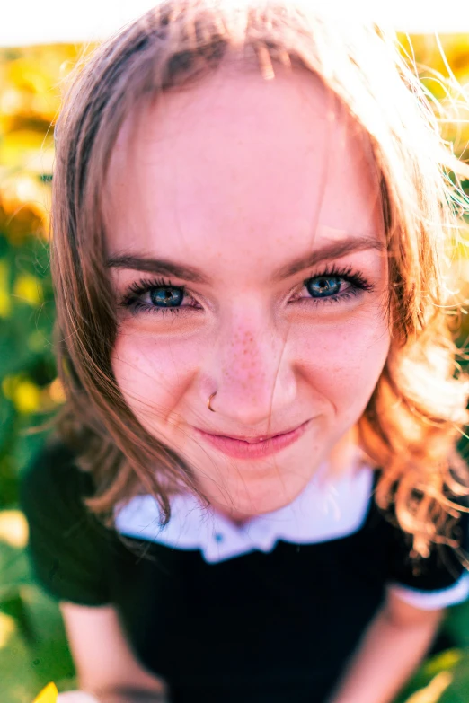 a woman smiling as she sits on the ground