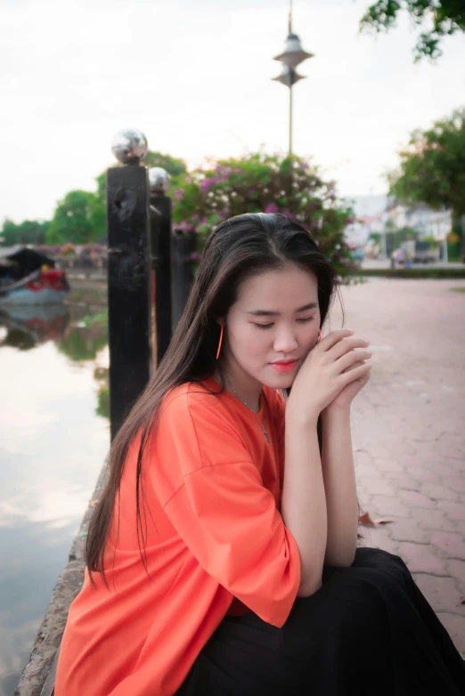 the girl is sitting down on the dock