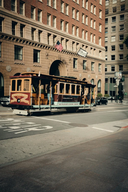 a trolley car drives past an old building