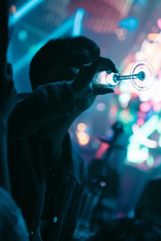 man holding a glass up to his eye