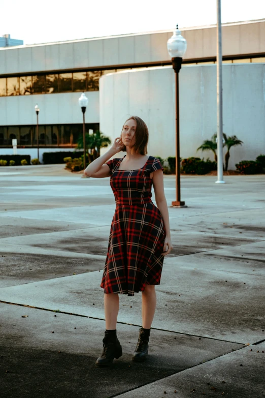 a young woman in a dress talking on a cell phone