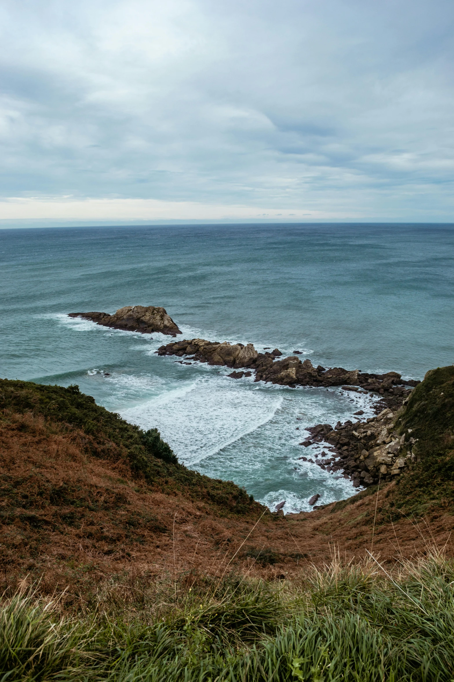 a rocky area with a body of water in the distance