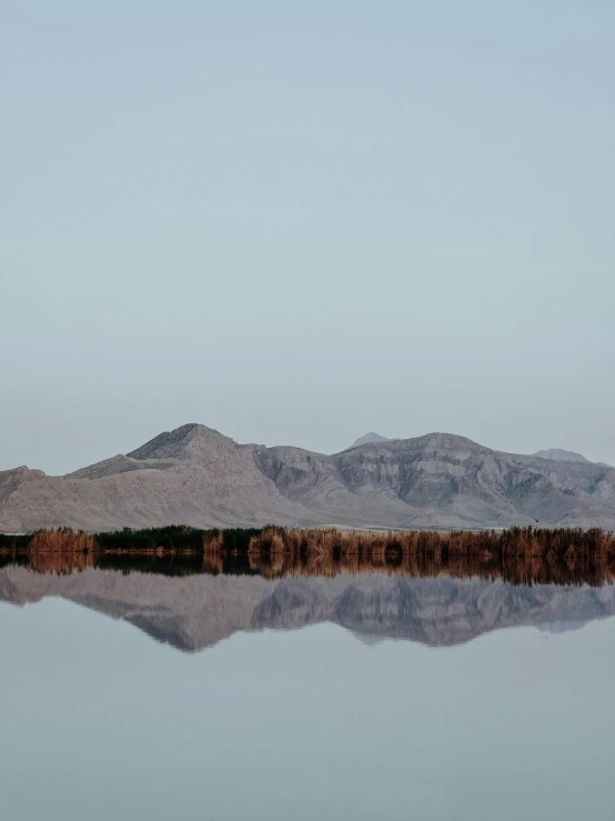 a lake with mountains reflected in the water