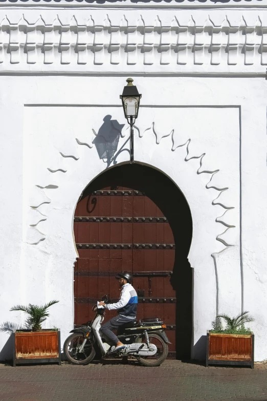 a man riding a motorcycle down the street