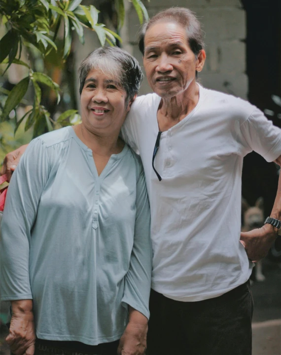 man and woman smiling for po by plants