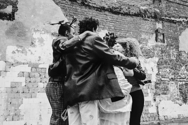 three people with one holding a bird on the street