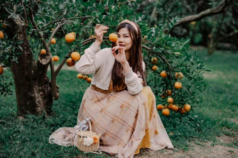 a woman in a long dress eating a apple