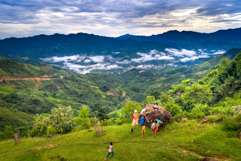 three people are climbing a mountain in the wilderness