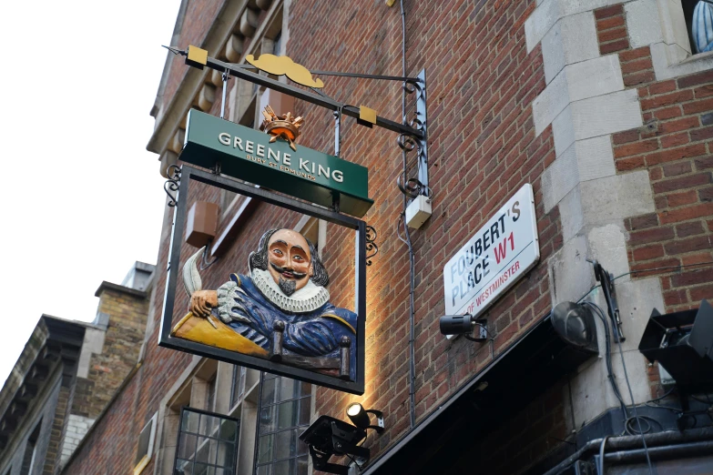 a sign on the side of a building that has a picture of a gentleman holding a fish