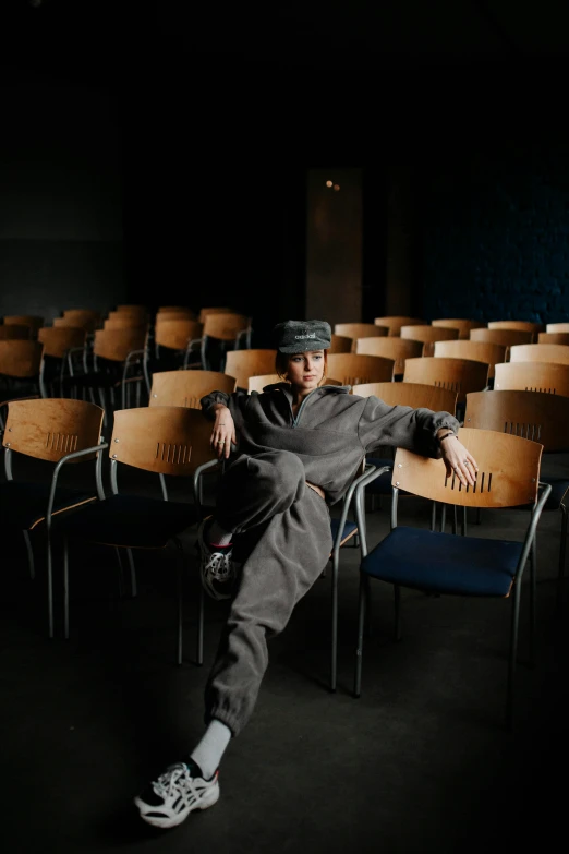 a man sitting in an empty chair, with one foot up