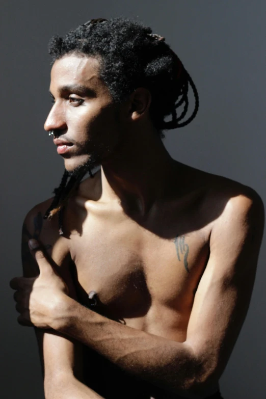 a man with a black tie and an unusual piercing on his head