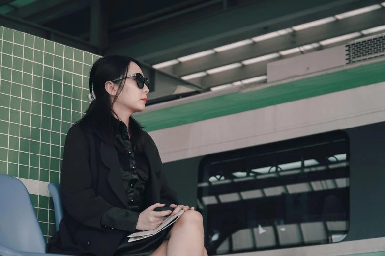 a person sitting down by a subway