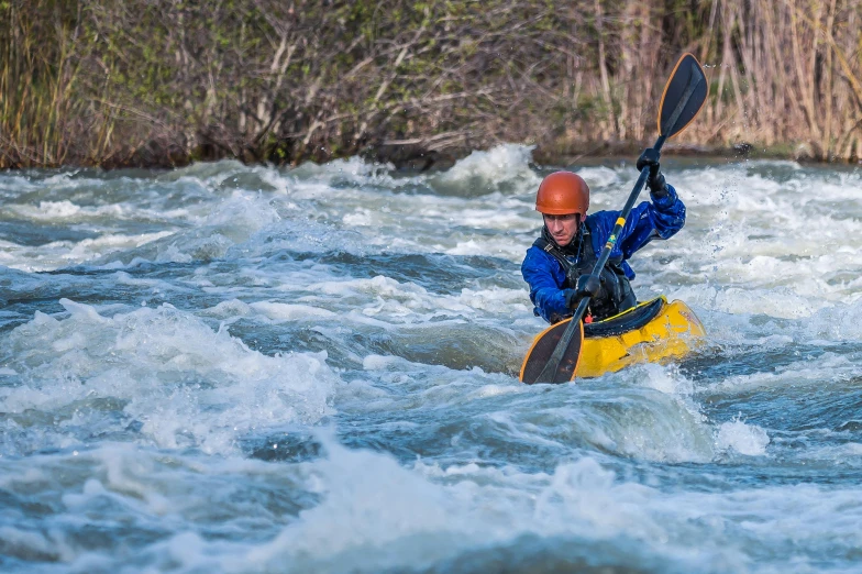 there is a man paddling a kayak in the water