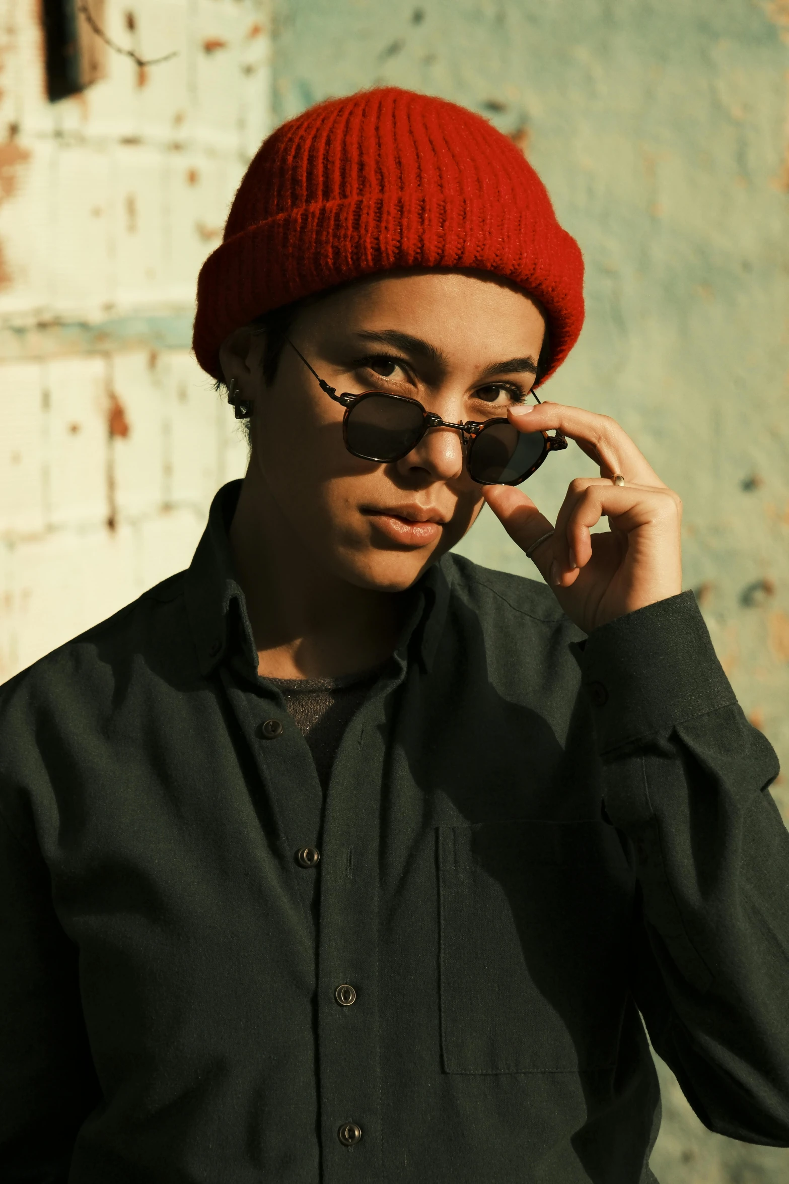 a man in black shirt wearing sunglasses and a red hat