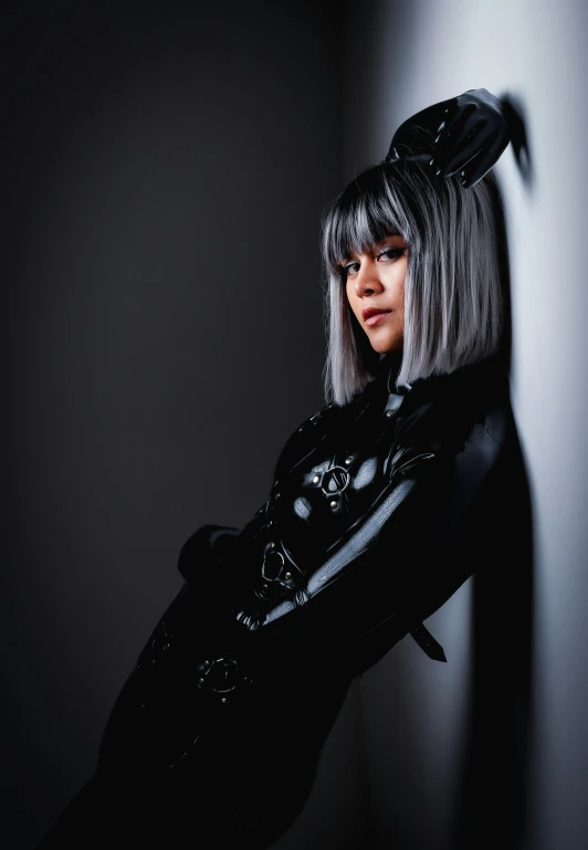 a woman in cat - clawed black outfit posing for the camera