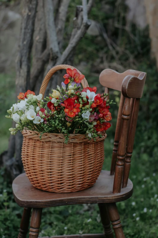 a chair with a basket and flowers in it