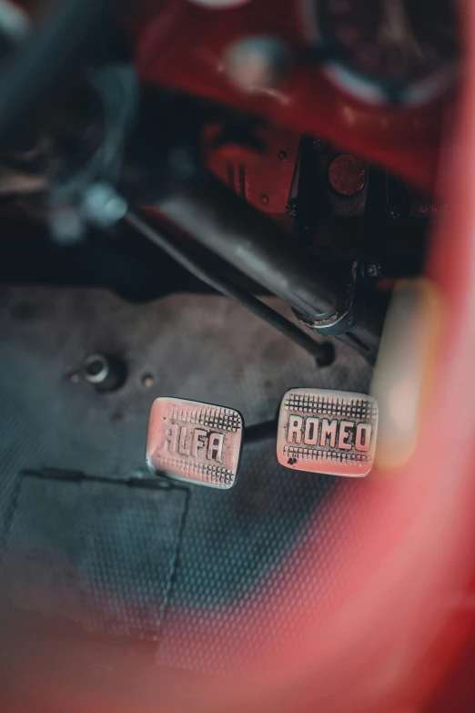 two tokens sit next to a red car