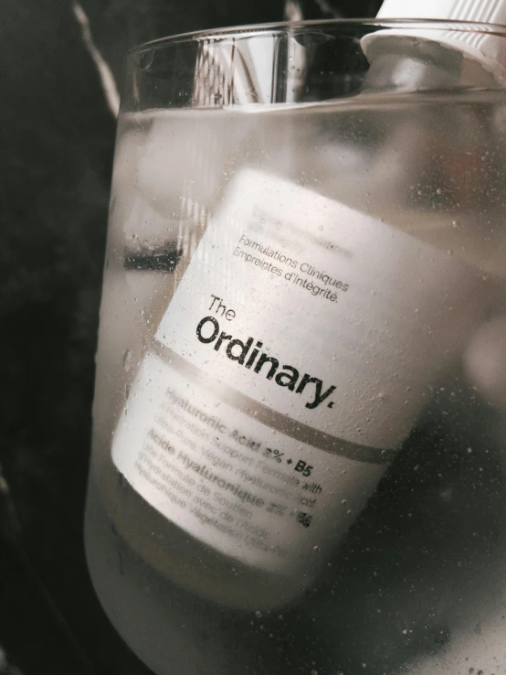 the ordinary bottle is partially filled with a liquid