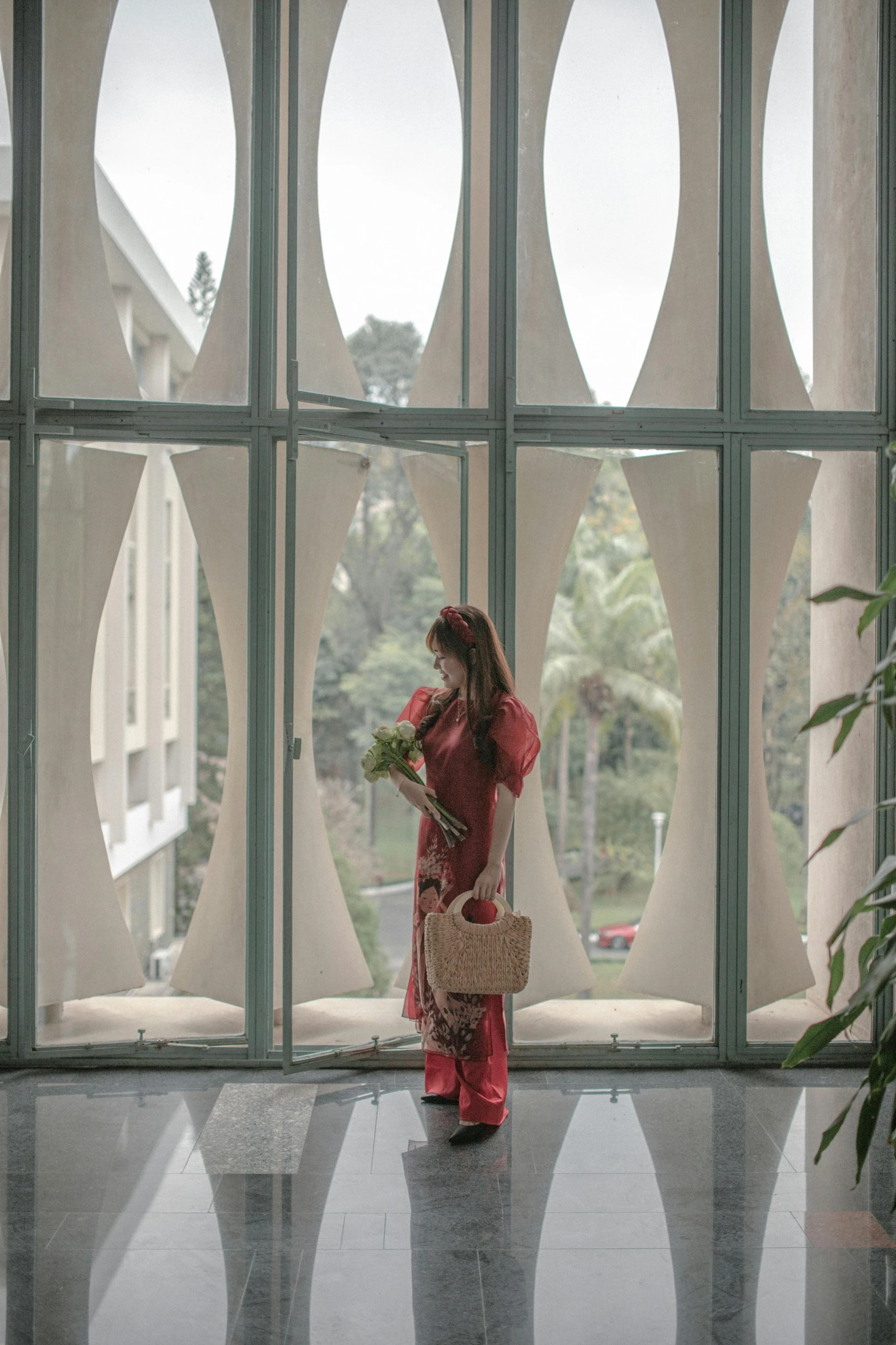 a woman in a pink outfit is looking out of the glass