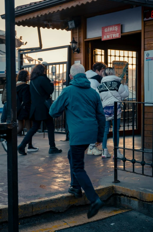 a group of people are walking towards a door